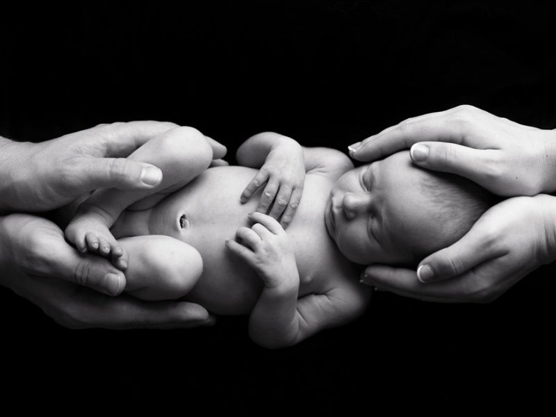 newborn-baby-in parents-hands