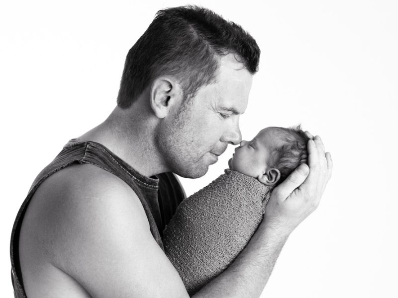 father-holding-newborn