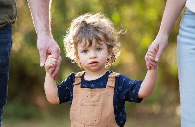 little_boy_holding_parents_hands